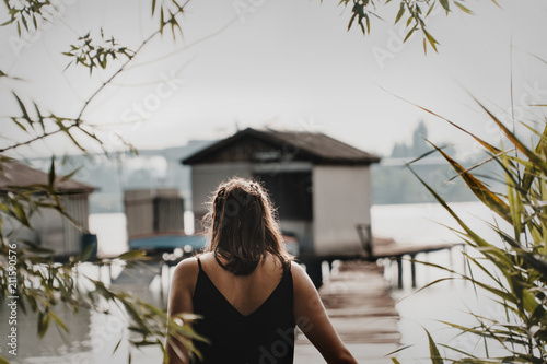 traveller girl walking on a pier photo