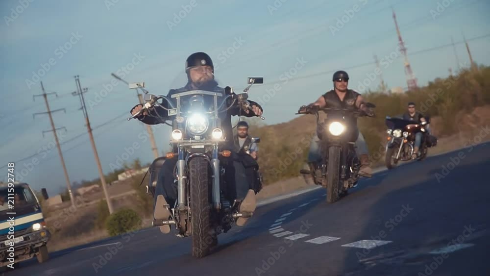 a lot of subculture bikers group ride on the track on a Sunny summer day on custom motorcycles, a large-scale action of motorcyclists. a passion for traveling by a group of men a lot of subculture bikers group ride on the track on a Sunny summer day on custom motorcycles, a large-scale action of motorcyclists. a passion for traveling by a group of men