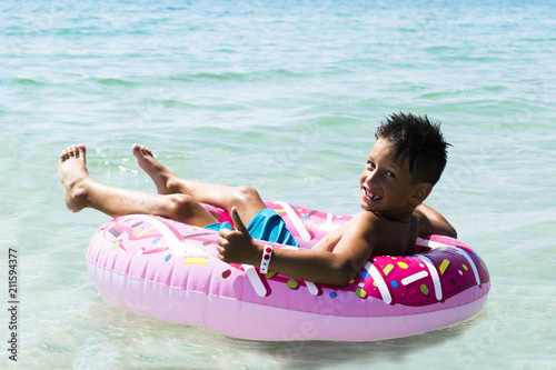 Child with inflatable ring in sea photo
