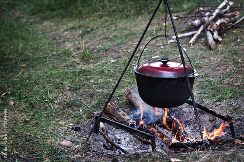 Bowler over the fire. Food on the campaign, in nature.