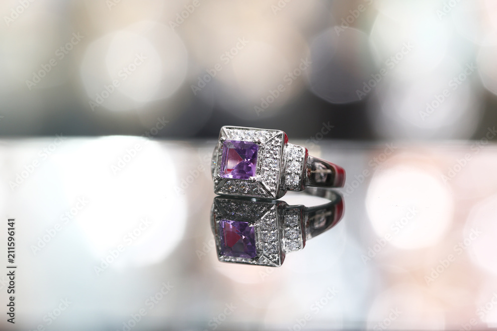 Purple gemstone on diamond ring Purple gemstone on diamond ring