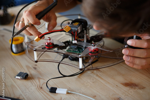 Image of young man with soldering iron chipping mechanism