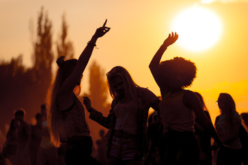Sunset party dancers silhouettes at summer music festival