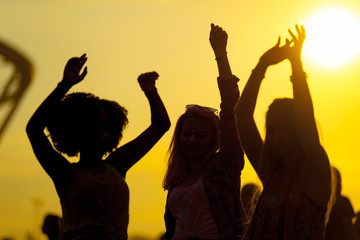 Sunset party dancers silhouettes at summer music festival