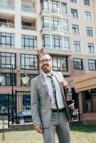 Wallpaper Mural handsome bearded businessman in suit with leather bag in city Torontodigital.ca