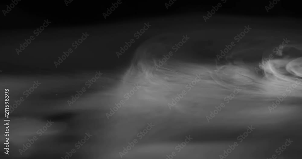 Creeping fog Dissolves in the Dark. Heavy white smoke slowly spreads over the black surface gradually dissolving Creeping fog Dissolves in the Dark. Heavy white smoke slowly spreads over the black surface gradually dissolving