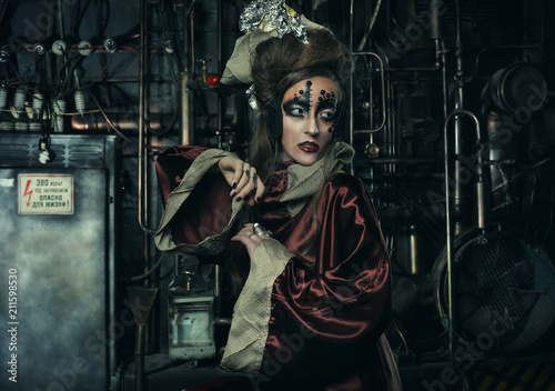 Aggressive stylish steampunk lady in a creative interior. Art an fashion concept.