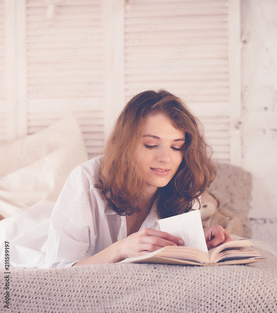 beautiful blond woman reading book in the bed. Relaxing concept beautiful blond woman reading book in the bed. Relaxing concept