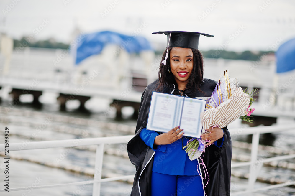 1970s YOUNG AFRICAN AMERICAN WOMAN GRADUATE IN WHITE CAP AND GOWN LOOKING  AT CAMERA - Stock Photo - Masterfile - Rights-Managed, Artist:  ClassicStock, Code: 846-08512730