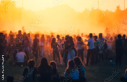Crowd at summer music festival, blurred people during concert