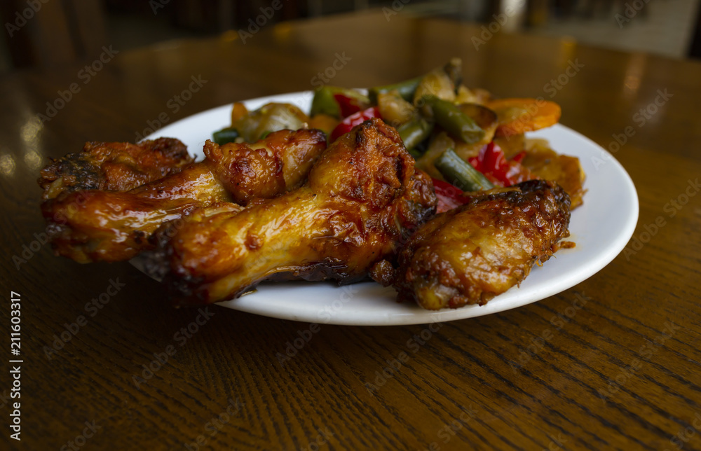 Spicy chicken wings with stewed vegetables. Spicy chicken wings with stewed vegetables.