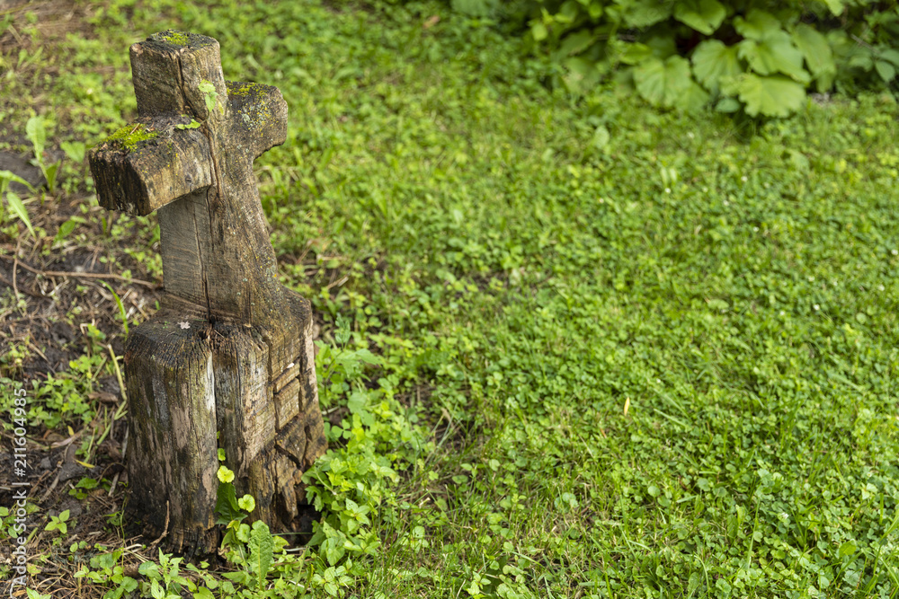 Fototapeta premium Grave Marker / A wooden grave marker with carved cross and the word love.