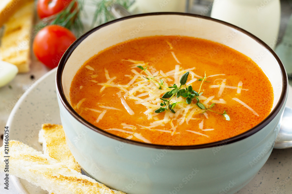 Puree soup tomato with croutons and cheese in a bowl close-up on a light slate background. Diet menu. The concept of healthy eating. Puree soup tomato with croutons and cheese in a bowl close-up on a light slate background. Diet menu. The concept of healthy eating.