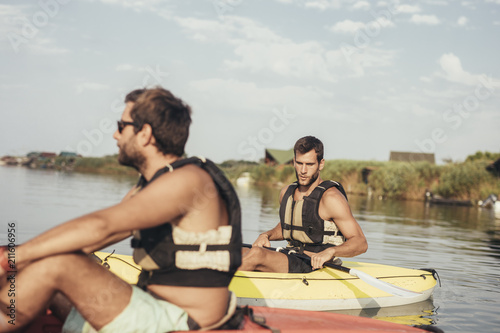Two Men Kayaking on the River