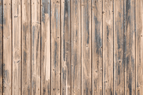 Brown wooden boards of oak color. Vintage old fence or wall of house. Fittings of screws. Background abstract pattern.