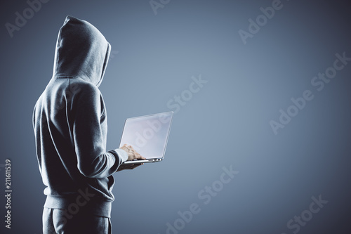 hacker holding laptop