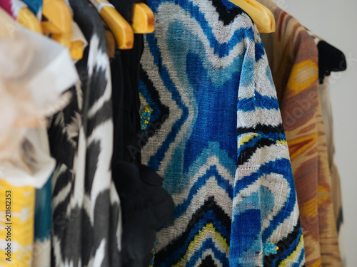 Bright clothes on wooden hangers