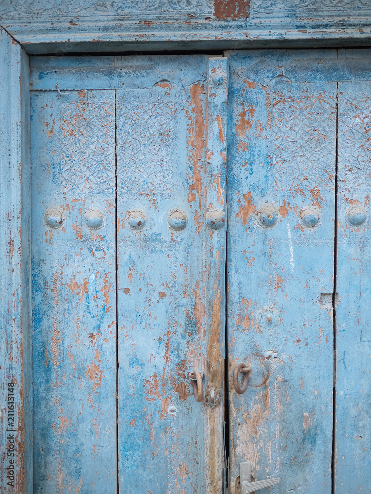 Aged wooden door in metal rivets Aged wooden door in metal rivets