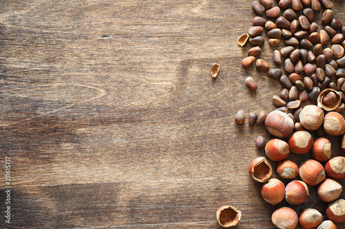 Different nuts on a wooden table. Cedar, cashew, hazelnut, walnu