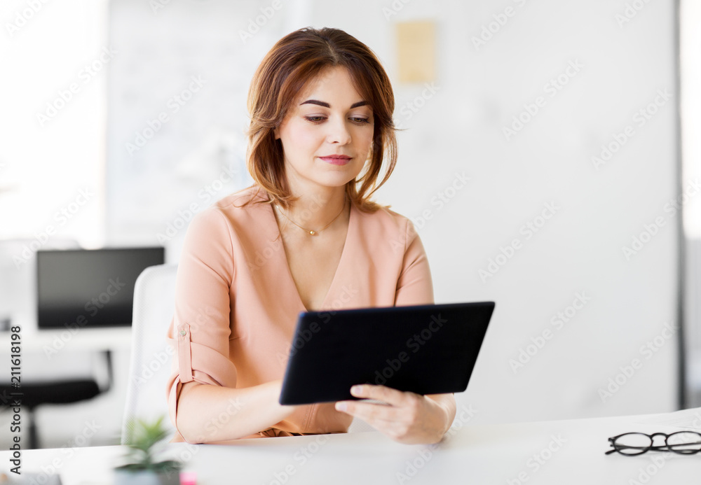 business, technology and people concept - businesswoman with tablet pc computer working at office