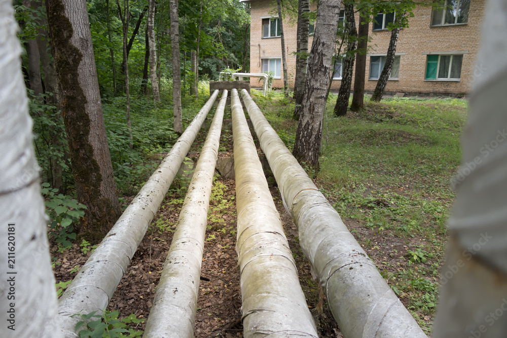 Laying of heat-insulated large diameter pipes for hot water supply during the construction of a residential area. Pipes are insulated with special materials. Are above the ground. Laying of heat-insulated large diameter pipes for hot water supply during the construction of a residential area. Pipes are insulated with special materials. Are above the ground.
