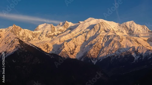 Mont Blanc mountain range. Timelapse from sunset to twilight. The view includes from left to right, Aiguille du Midi needle, Mont Blanc du Tacul and Mont Blanc. Chamonix, Haute-Savoie, Alps, France