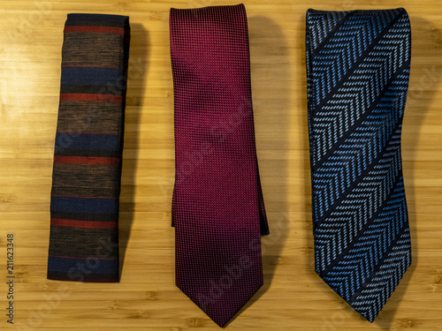 Three ties in a row displaying different styles
