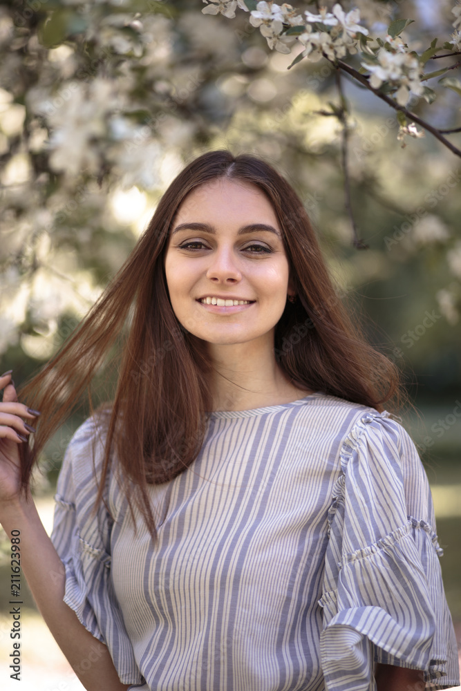 Pretty young woman in a summer garden, casual romantic style with hat Pretty young woman in a summer garden, casual romantic style with hat