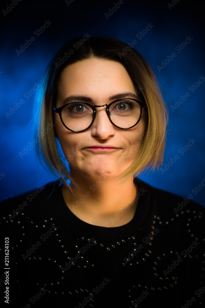 portrait emotional young girl on blue background