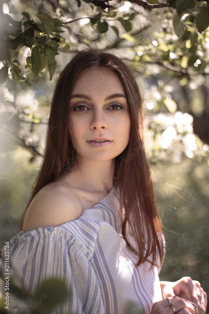 Pretty young woman in a summer garden, casual romantic style with hat Pretty young woman in a summer garden, casual romantic style with hat