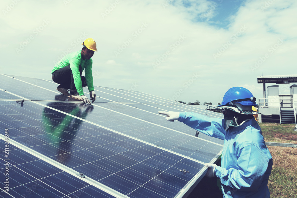 engineer team working on replacement solar panel in solar power plant;engineer and electrician team swapping and install solar panel after solar panel voltage drop engineer team working on replacement solar panel in solar power plant;engineer and electrician team swapping and install solar panel after solar panel voltage drop