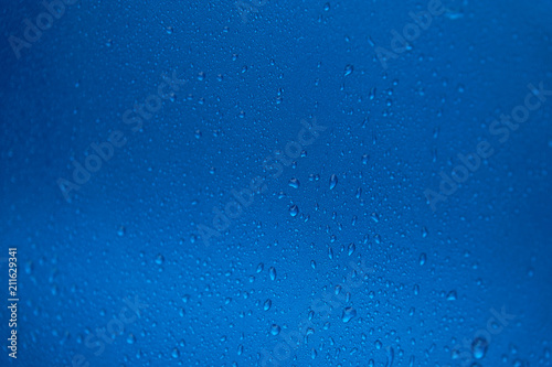 Rain drops on a blue smooth surface.