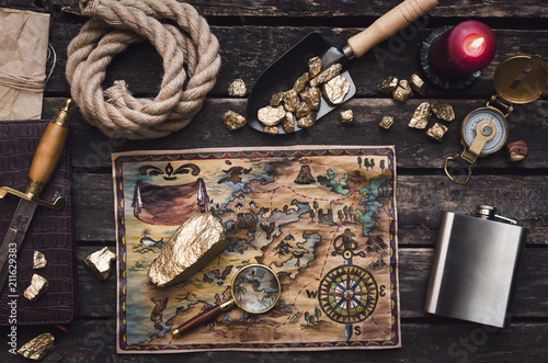 Fotografie Old treasure map on adventurer or pirate table