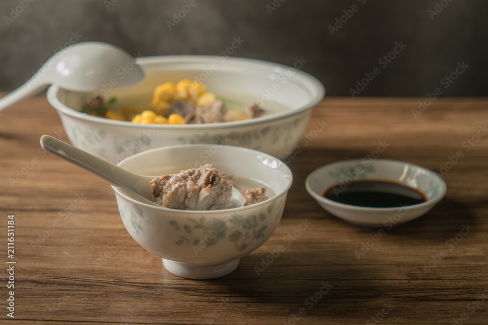 Corn bone soup, wood grain background Corn bone soup, wood grain background