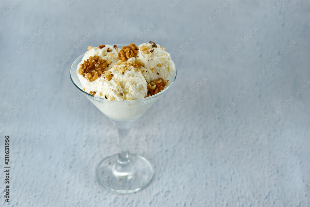 Ice cream in a glass bowl with walnuts and meringue Ice cream in a glass bowl with walnuts and meringue
