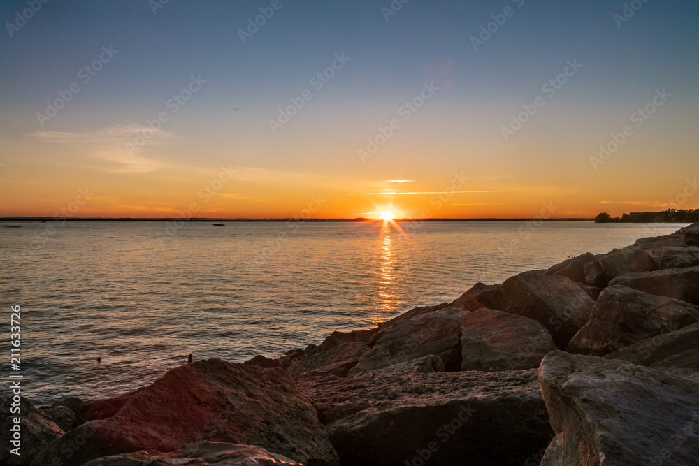Sunset over Lake with a Rock Shoreline