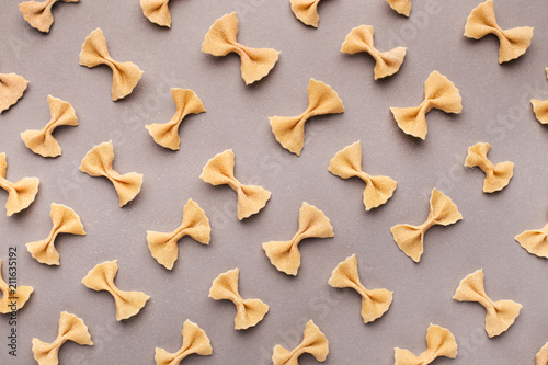 Bow tie Italian pasta fartalle pattern on grey background photo