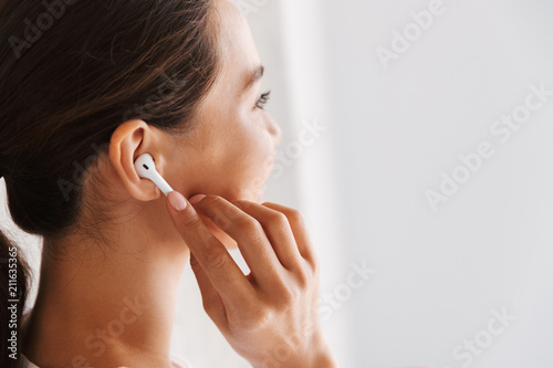 Close up of a smiling asian woman listening to music
