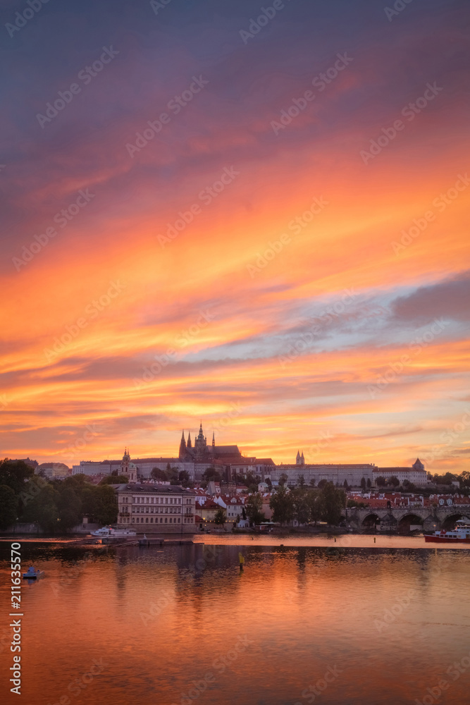 Vertical view on Prague gothic Castle with Charles Bridge after the sunset, Czech Republic - Beautiful reflections of Vltava river and clouds