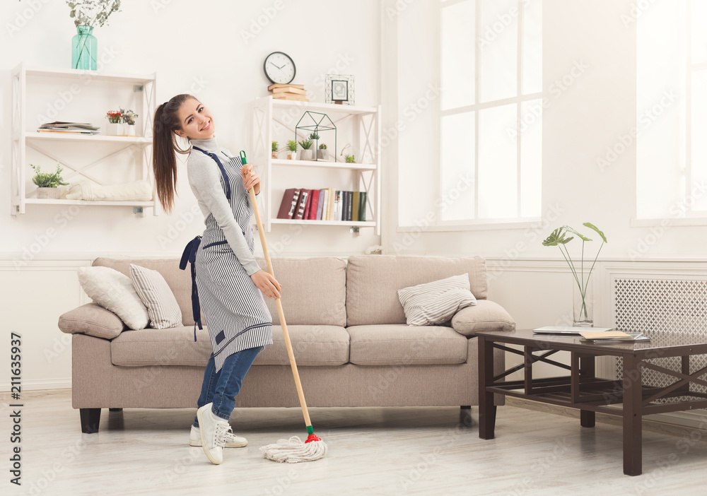 Happy woman cleaning home with mop and having fun Happy woman cleaning home with mop and having fun
