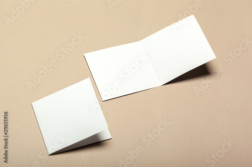 Blank paper pieces for mock up on a beige background