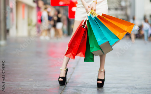 Beautiful Shopping woman with colorful shopping bags walking in the mall. Happy woman concept.