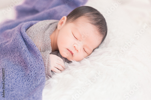New born baby lying on a soft blanket. Cute new born baby in natural motion.
