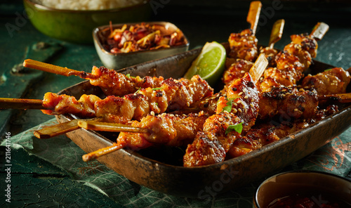 Barbecued satay skewers with diced seasoned meat photo