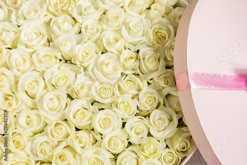 Fototapeta Naklejka Na Ścianę i Meble -  Round large box with white roses wrapped in roses
