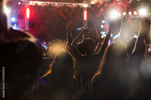 Audience take a photo on mobile phone at a free night concert music festival.