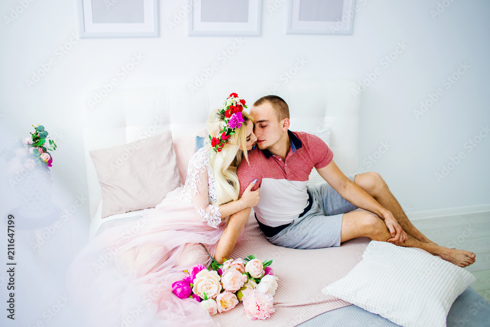 A beautiful couple kissing on the bed