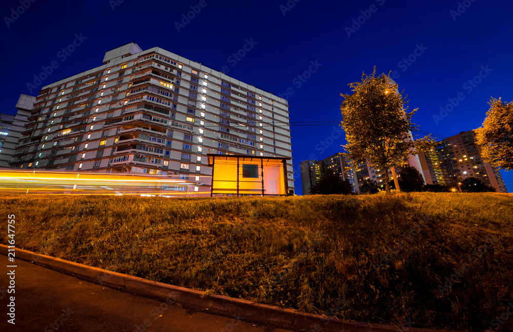 Night scenery of the cityscape, house and bus stop
