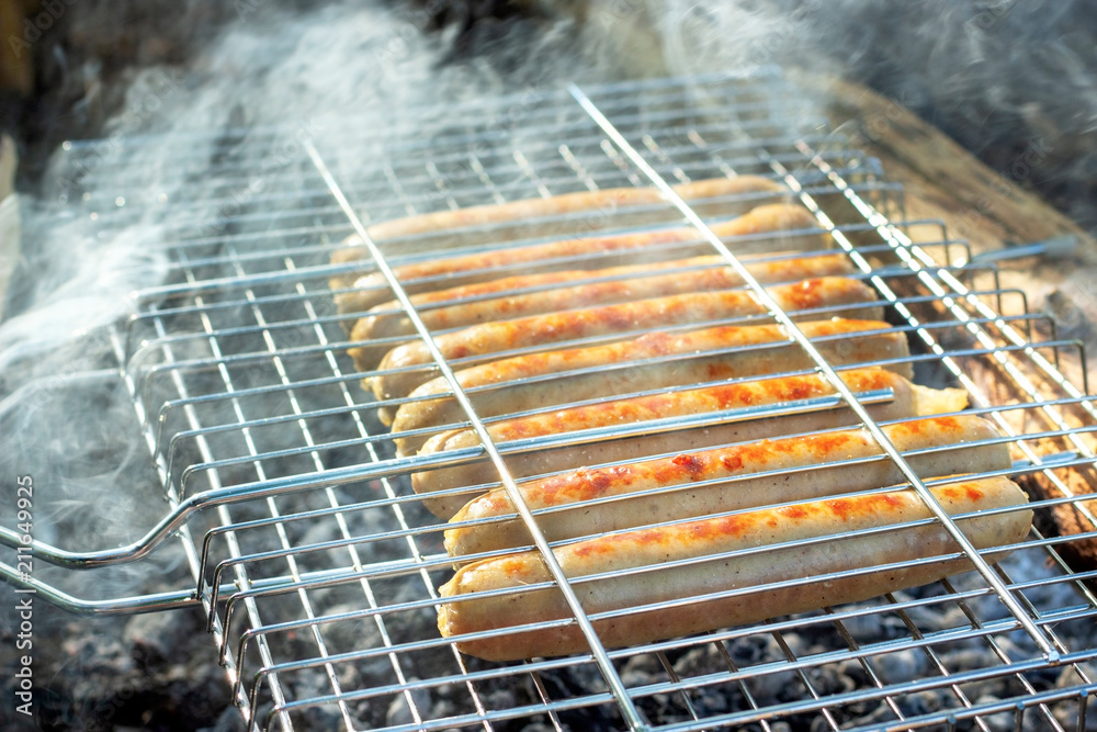 delicious  Grill sausages fried on open fire, picnic outdoors