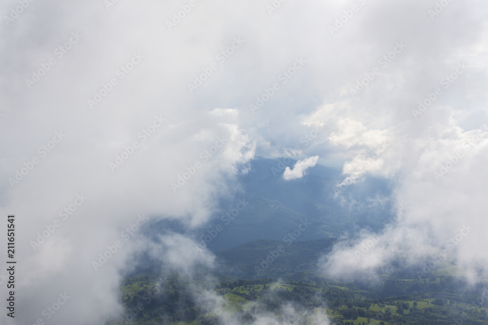 Fototapeta premium Summer scenery in the mountains, with rain and mist clouds
